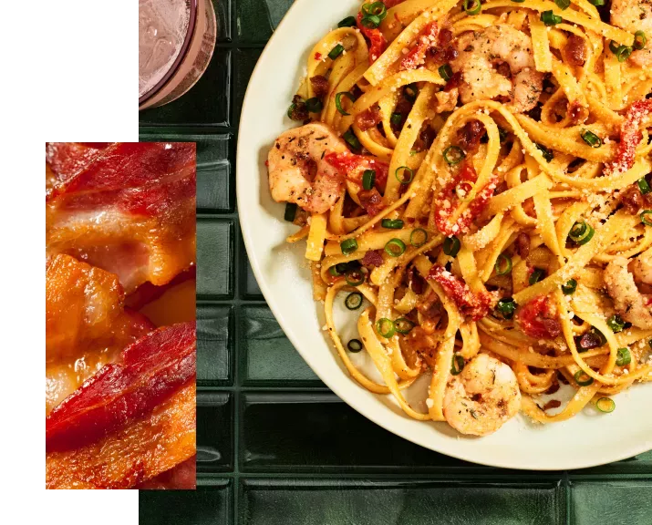Bacon and cajun shrimp fettuccine on table top.