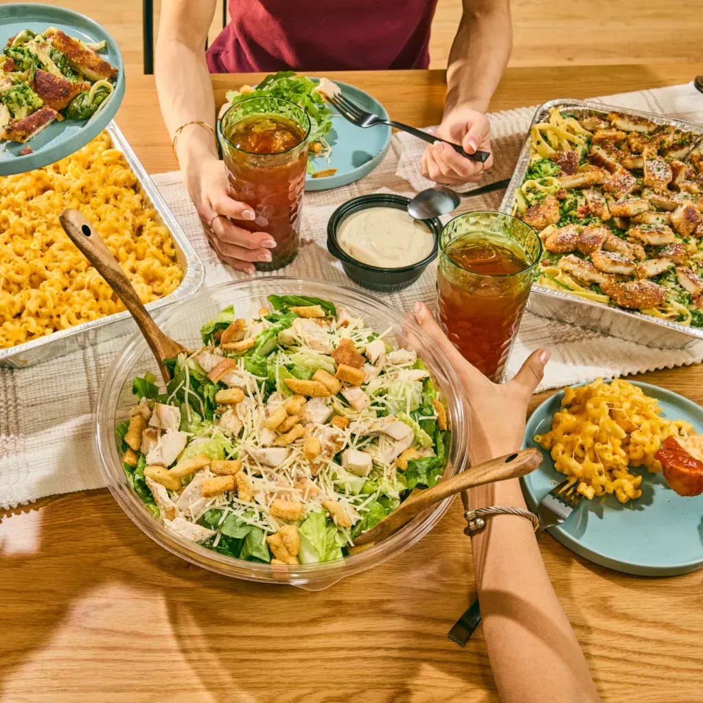 Noodles &amp; Company catering dishes, included a Caesar Salad, Pan of Mac and Cheese, and Pan of Alfredo