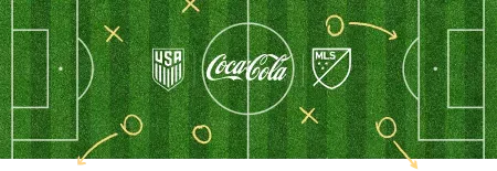 Coca Cola, USA Soccer Team and Major League Soccer logos over a grass soccer field with X's and O's.