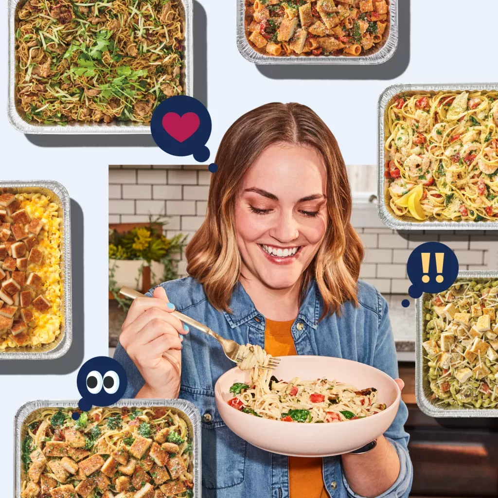 Noodles &amp; Company customer enjoying a serving of noodles with multiple catering options in pans surrounding the customer.