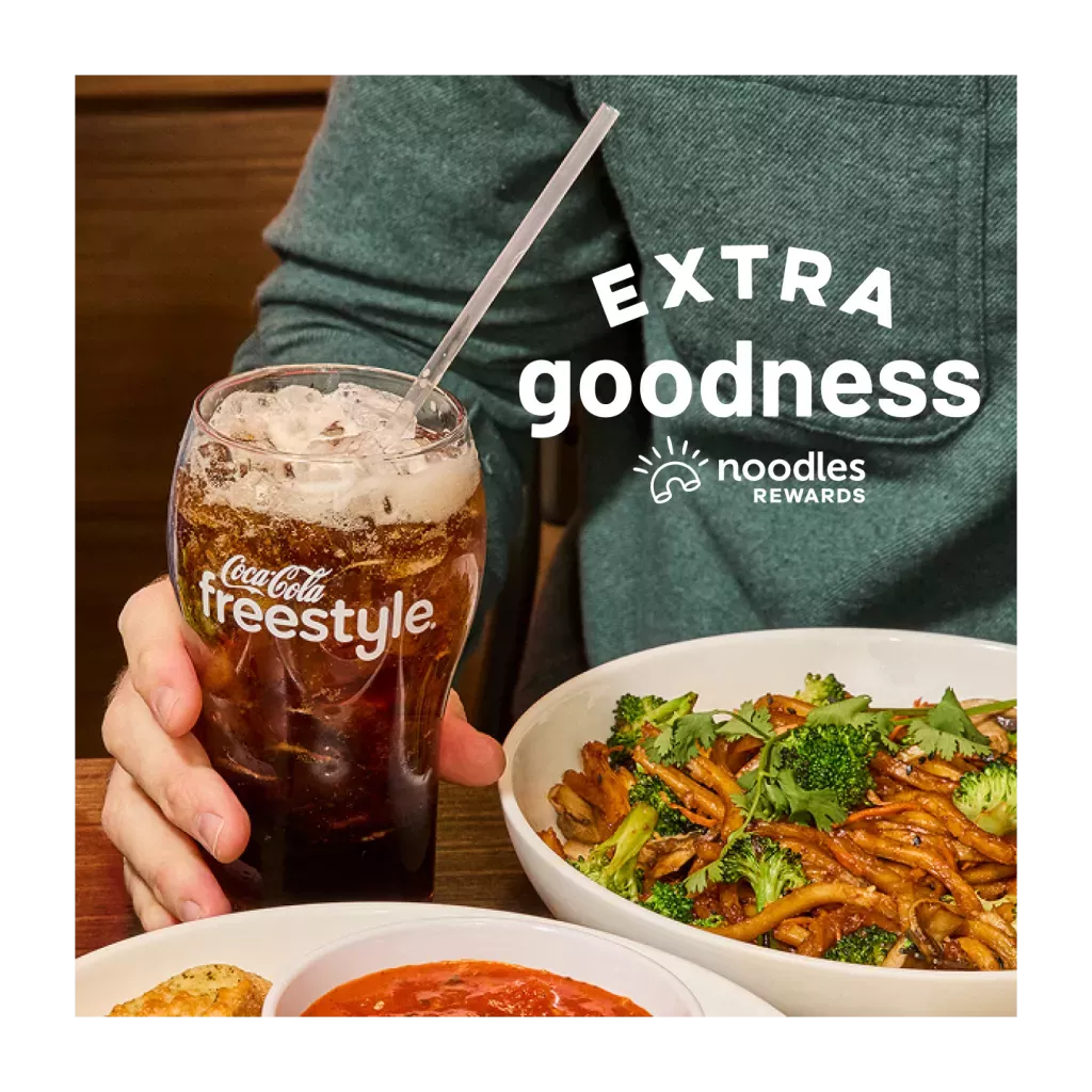 Extra Goodness. Noodles Rewards Logo. Coca-Cola Freestyle Fountain Drink. Bowl of Japanese Pan Noodles on a table with a customer.