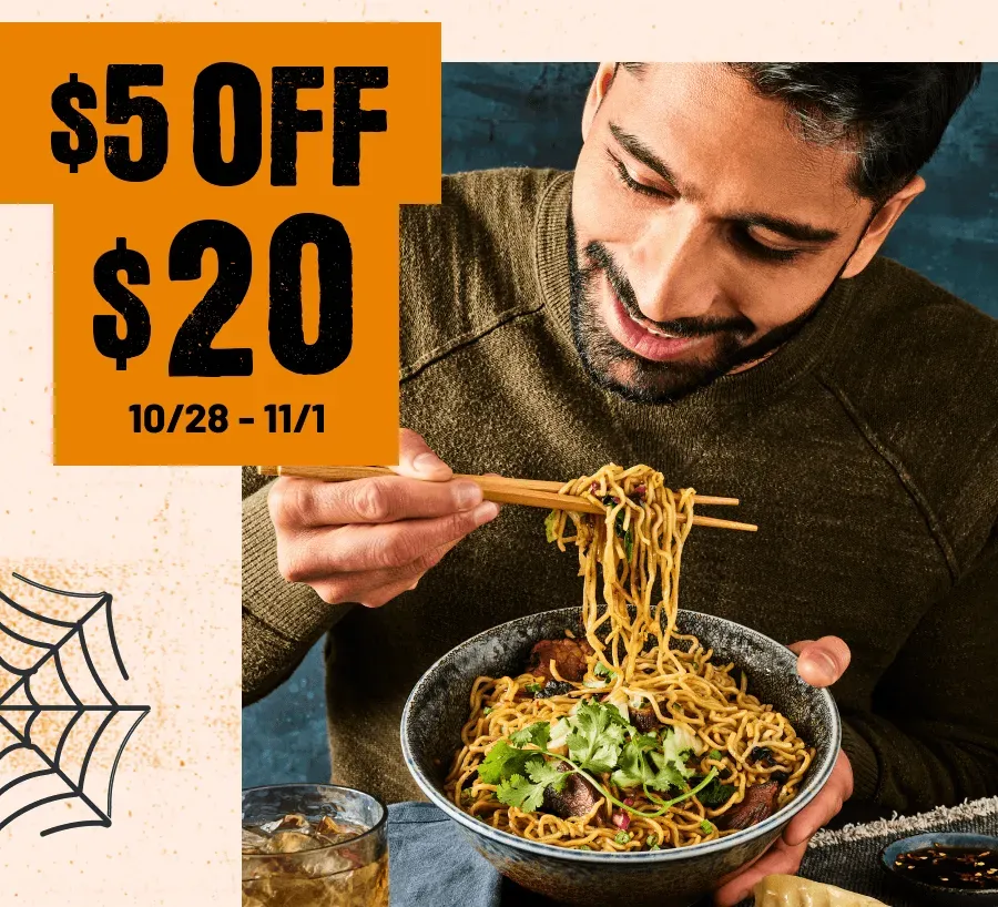 $5 off $20 10/28-11/1. Man eating a Spicy Korean Steak Ramen