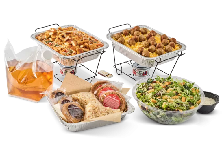 Noodles & Company catering pans, dessert, drink, and salad.