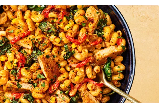Noodles & Company's Chipotle Chicken Cavatappi with gold spoon