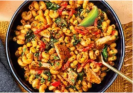 Tabletop image of chipotle chicken cavatappi and a fork