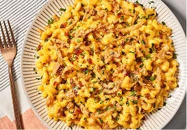 Tabletop image of garlic bacon crunch mac and cheese and a fork