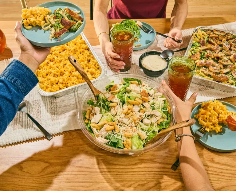 Noodles &amp; Company catering dishes, included a Caesar Salad, Pan of Mac and Cheese, and Pan of Alfredo