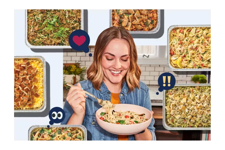 Noodles &amp; Company customer enjoying a bowl of noodles with catering pans decorating the background.