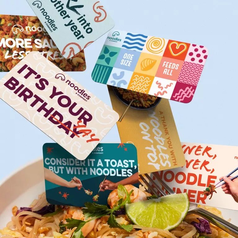 Noodles &amp; Company Gift Cards being dumped into a bowl of Pad Thai.