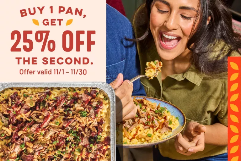 Buy 1 pan, Get 25% off the second. Offer valid 11/1-11/30. Catering pan of Pulled Pork Mac. Customers enjoying a serving of pulled pork mac.